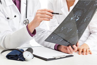 Two health professionals looking at film x-rays.