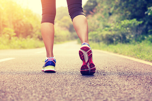 Woman running on road.