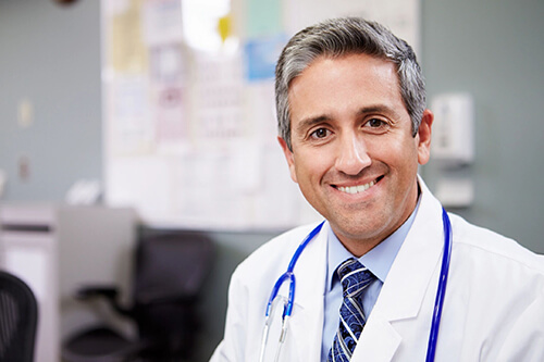 Male doctor smiling at camera.