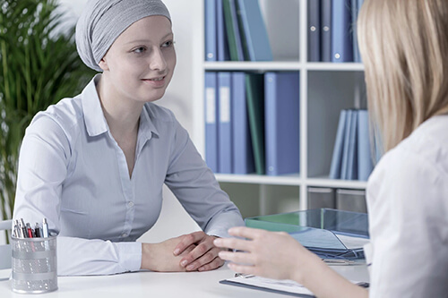 Female patient talking to female health professional in office.